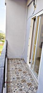 a room with a tile floor next to a window at Luxury Apt with Mountain View in Jāmb +15 photos