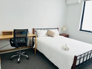 a bedroom with a bed and a desk and a chair at Rooms to share In heart of Asian Vietnamese area in St Albans +4 photos