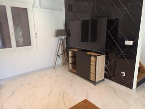 a television sitting on a stand in a room at appartements familial in Vias
