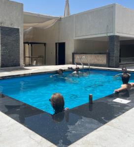 a group of people in a swimming pool at Villa Khufu Pyramids Hotel in Cairo