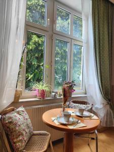 a table in front of a window with two cups on it at Cozy small apartment in Vienna