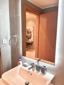 a bathroom with a sink and a mirror at The Damac apartment in Amman