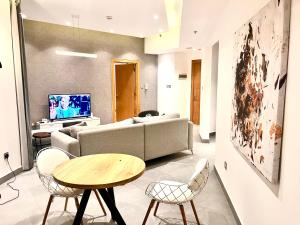 a living room with a couch and a table at The Damac apartment in Amman +32 photos