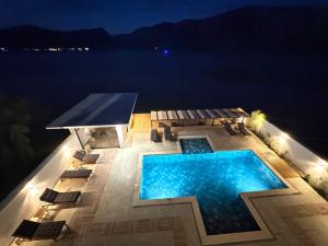 an overhead view of a swimming pool at night at Harmony House - Adults Only in Dubova +13 photos