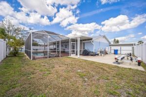 an exterior view of a house with a large yard at Apollo Beach Retreat - 3BR - Pool - Backyard -BBQ in Apollo Beach