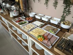 a buffet with different types of food on a table at Kraków Garden Hotel - Bezpłatny parking in Krakow +26 photos