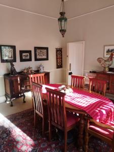 a dining room with a table and chairs with a red blanket at Smithfield House in Smithfield +29 photos