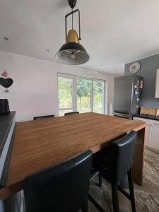 a dining room with a wooden table and chairs at PANORAMA Małe Swornegacie in Małe Swornegacie