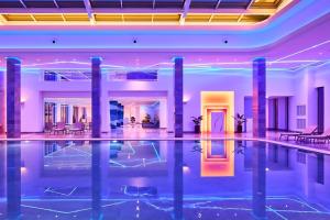 a swimming pool in the middle of a building at ToSea Apartment by Melia in Lalzit Bay