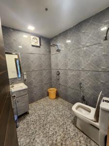 a bathroom with a toilet and a sink at Rosewood farms in Noida +22 photos