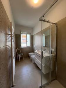 a bathroom with a shower and a toilet and a sink at Mirella's cute place Udine in Udine +19 photos