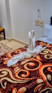 A bed or beds in a room at Summer Land Hotel