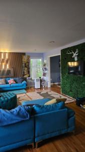 a living room with two blue couches in it at Mountain View Villa with HotTub-MovieTheater Fire Pit Gameroom in West Milford