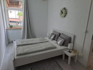 a white bedroom with a bed and a window at Apartment MICHAELA in Spital am Pyhrn +18 photos