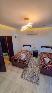 A bed or beds in a room at Summer Land Hotel