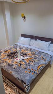 A bed or beds in a room at Summer Land Hotel