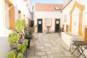 a courtyard with tables and chairs in a building at FixingInn in Santa Isabel in Lisbon