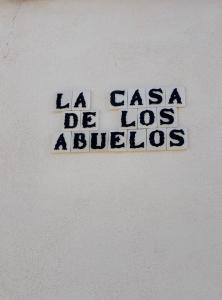 a sign on a wall that says la casa de los lobos at La Casa de los Abuelos in Mota del Cuervo