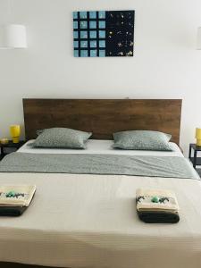 a bed with two towels sitting on top of it at ViMaJU in Koper