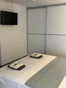 a room with a bed with two towels on it at ViMaJU in Koper