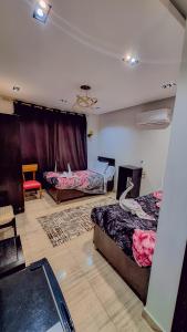 A bed or beds in a room at Summer Land Hotel