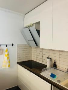a white kitchen with a sink and a mirror at ViMaJU in Koper +67 photos