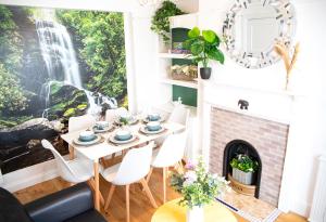 a dining room with a table and chairs and a fireplace at Brighton & Hove, 4 bedrooms, 5 beds, Garage in Brighton & Hove