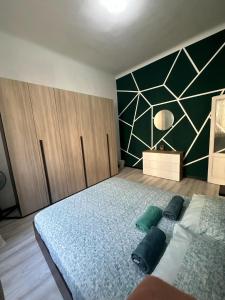 a bedroom with a bed with two pillows on it at VSuite Linate in Milan +7 photos