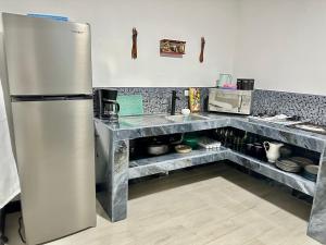 a kitchen with a stainless steel refrigerator at Paraiso En-suite #3 in Parrita +33 photos