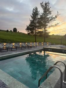 a swimming pool with a sunset in the background at Uvac lake "FF" in Sjenica