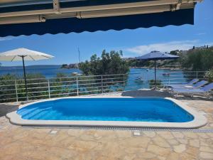 a swimming pool with a view of the water at Residence Summer By The Sea in Trogir