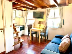 a living room with a blue couch and a table at FixingInn in Santa Isabel in Lisbon
