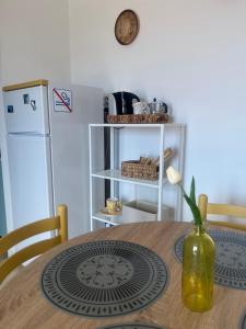 a kitchen with a wooden table and a refrigerator at Bella Vista La Bussola in Scalea