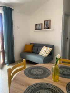 a living room with a couch and a table at Bella Vista La Bussola in Scalea
