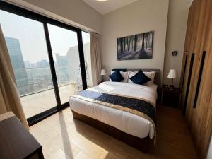 a bedroom with a large bed and a large window at 3BR Duplex Near Cleveland & Galleria Mall in Abu Dhabi +40 photos