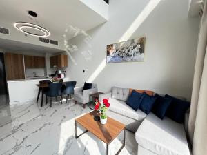 a living room with a couch and a table at 3BR Duplex Near Cleveland & Galleria Mall in Abu Dhabi