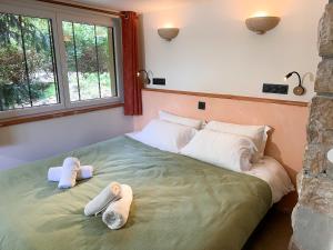 a bedroom with a large bed with towels on it at Maison Vaquier appartement in Yenne