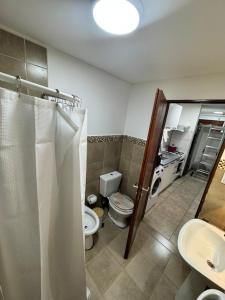 a bathroom with a toilet and a sink at Ushuaienses in Ushuaia