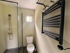 a bathroom with a toilet and a glass shower stall at Napu Puhkemaja in Rabivere +35 photos