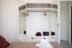 a room with a bed and a shelf with towels at Light View in Taormina +131 photos