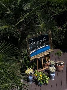 a chalkboard sign sitting on a table with plants at Apartments Franka in Samobor