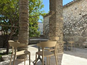 a group of chairs and tables in a courtyard at Xha Llukani in Berat +19 photos