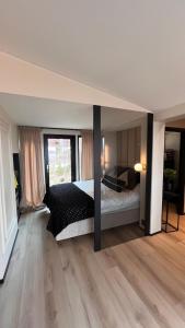a large bedroom with a bed and a wooden floor at High standard and beautiful view in Tennevika