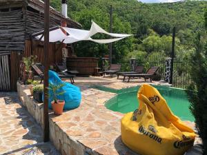 a backyard with a pool with a large yellow inflatable raft at Къща За Гости Двата Ореха in Protopopintsi