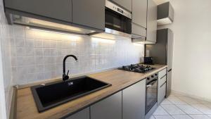 a kitchen with a sink and a stove at Il Fortino Residence - Three-room apartment La Maddalena in La Maddalena +14 photos