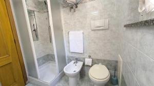 a bathroom with a toilet and a shower and a sink at Il Fortino Residence - Three-room apartment La Maddalena in La Maddalena
