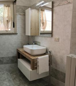 a bathroom with a sink and a mirror at Il Fortino Residence - Three-room apartment La Maddalena in La Maddalena