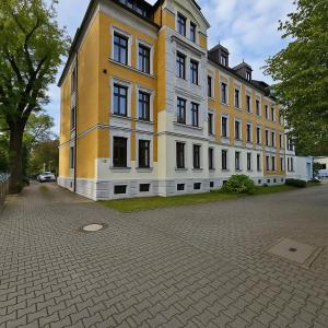 a large yellow and white building on a street at TOP ANGEBOT - große Wohnung - max 6 Personen - WiFi - Waschmaschine - Badewanne - 2 Parkplätze - zentrale Lage - große Küche TOP in Chemnitz