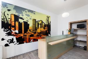 a kitchen with a city mural on the wall at Easy Housing in Prague