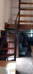 a staircase in a room with a chair and a couch at Casa do Forno in Sobreira Formosa